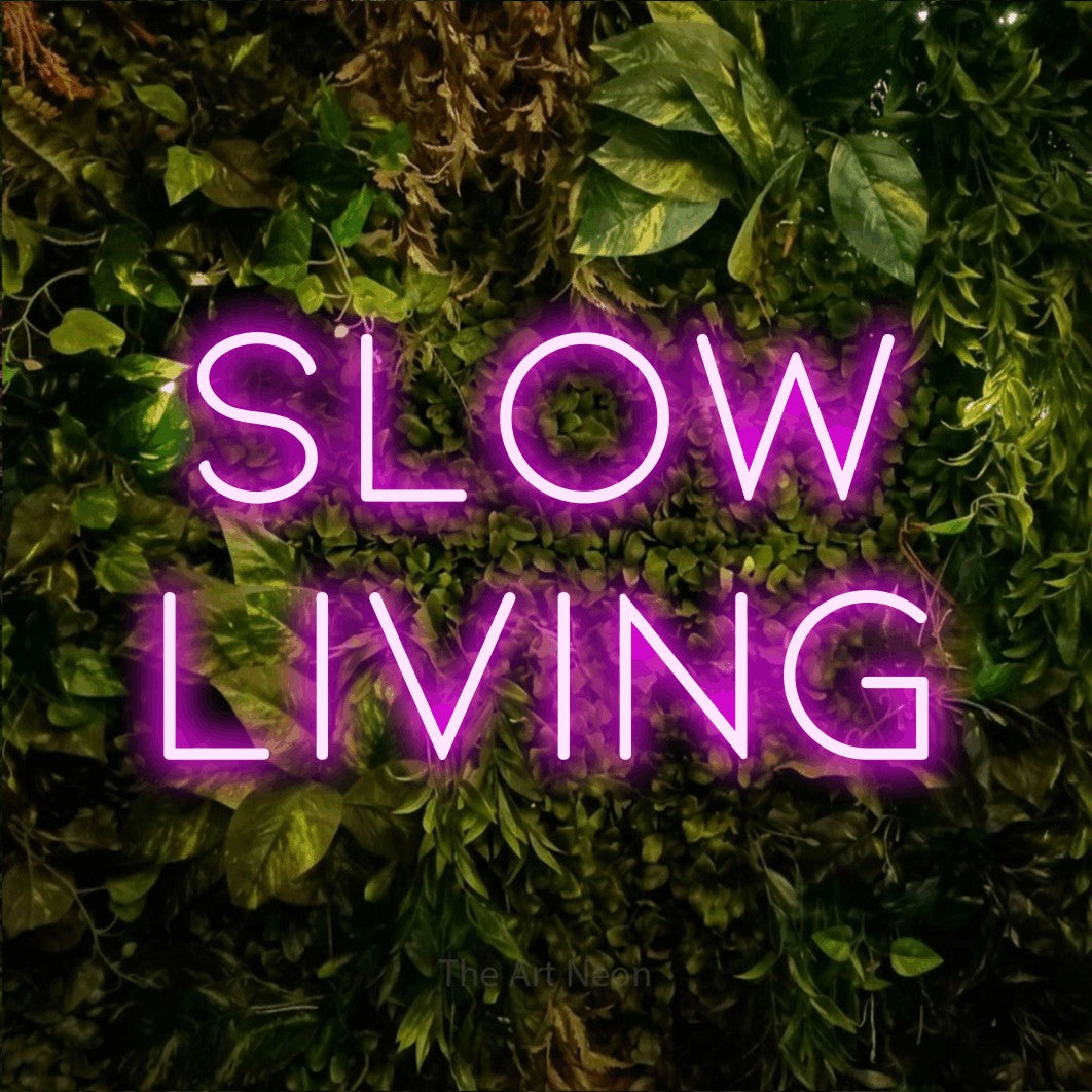 LED neon sign reading “slow living”, arranged in 2 lines.