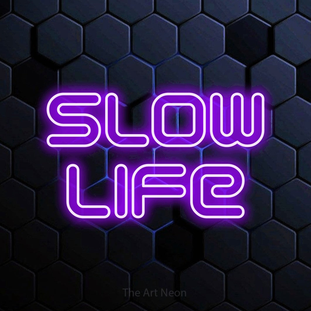 LED neon sign reading “slow life”, arranged in 2 lines.