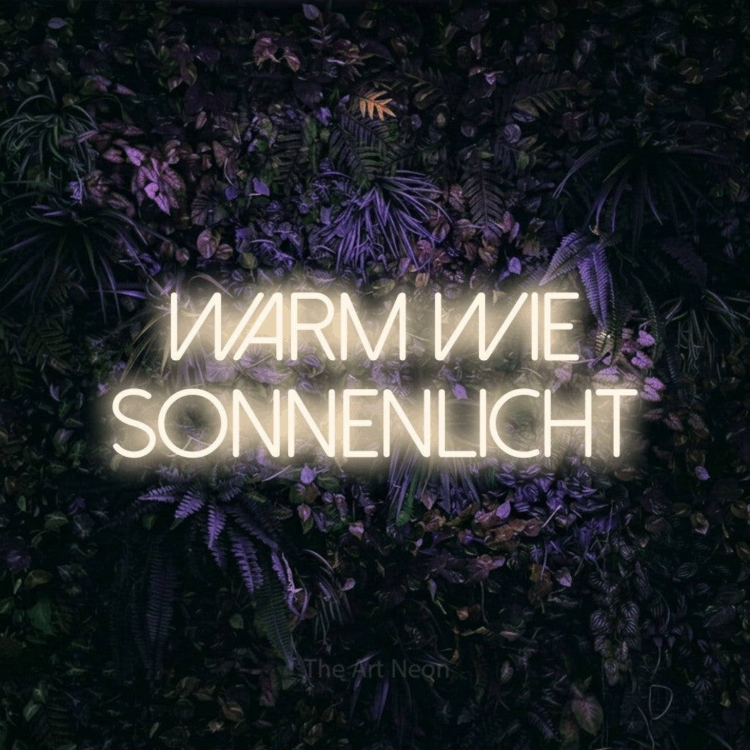 LED neon sign reading “Warm wie Sonnenlicht”, arranged in 2 lines.