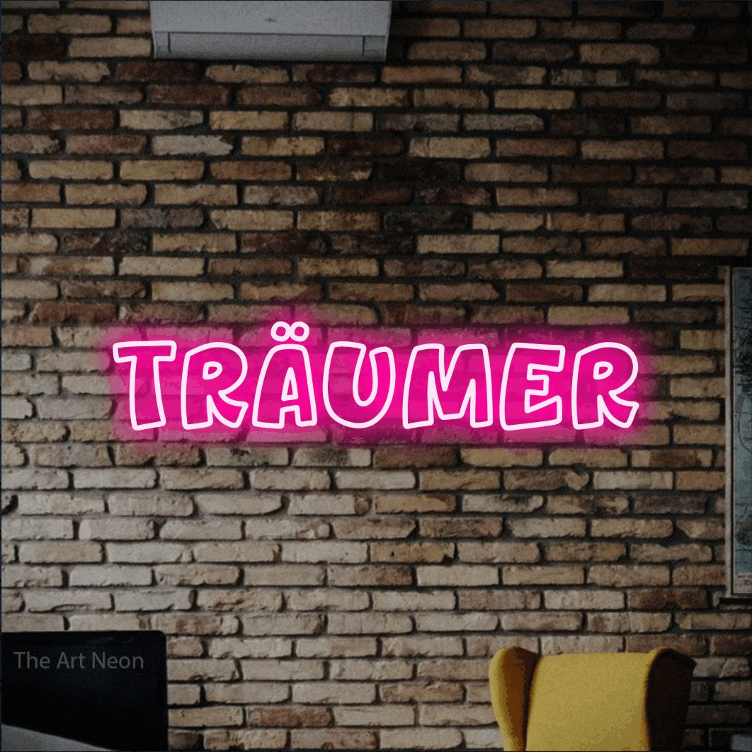 LED neon sign reading “träumer”, arranged in a single line.