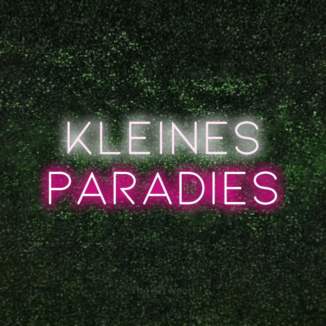 LED neon sign reading “kleines PARADIES”, arranged in 2 lines.
