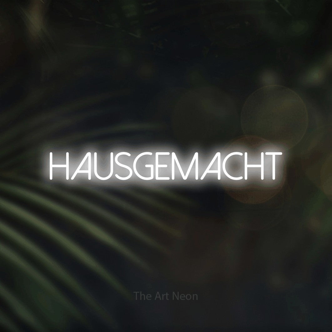 LED neon sign reading “HAUSGEMACHT”, arranged in a single line.