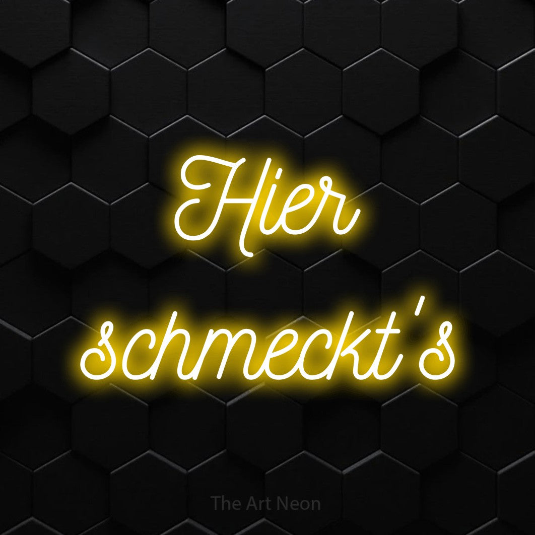 LED neon sign reading “Hier schmeckt's”, arranged in 2 lines.