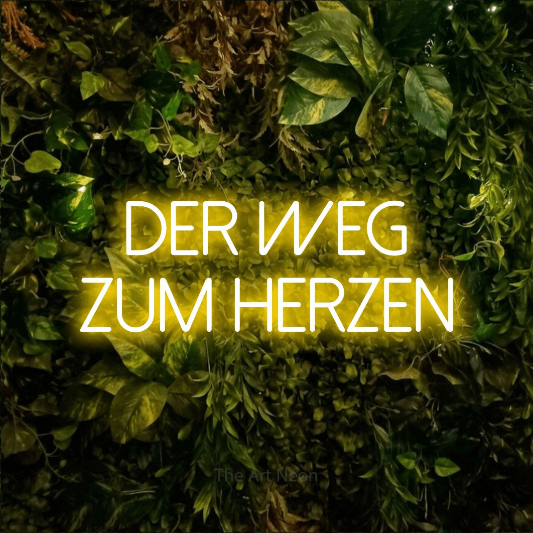 LED neon sign reading “Der Weg zum Herzen”, arranged in 2 lines.