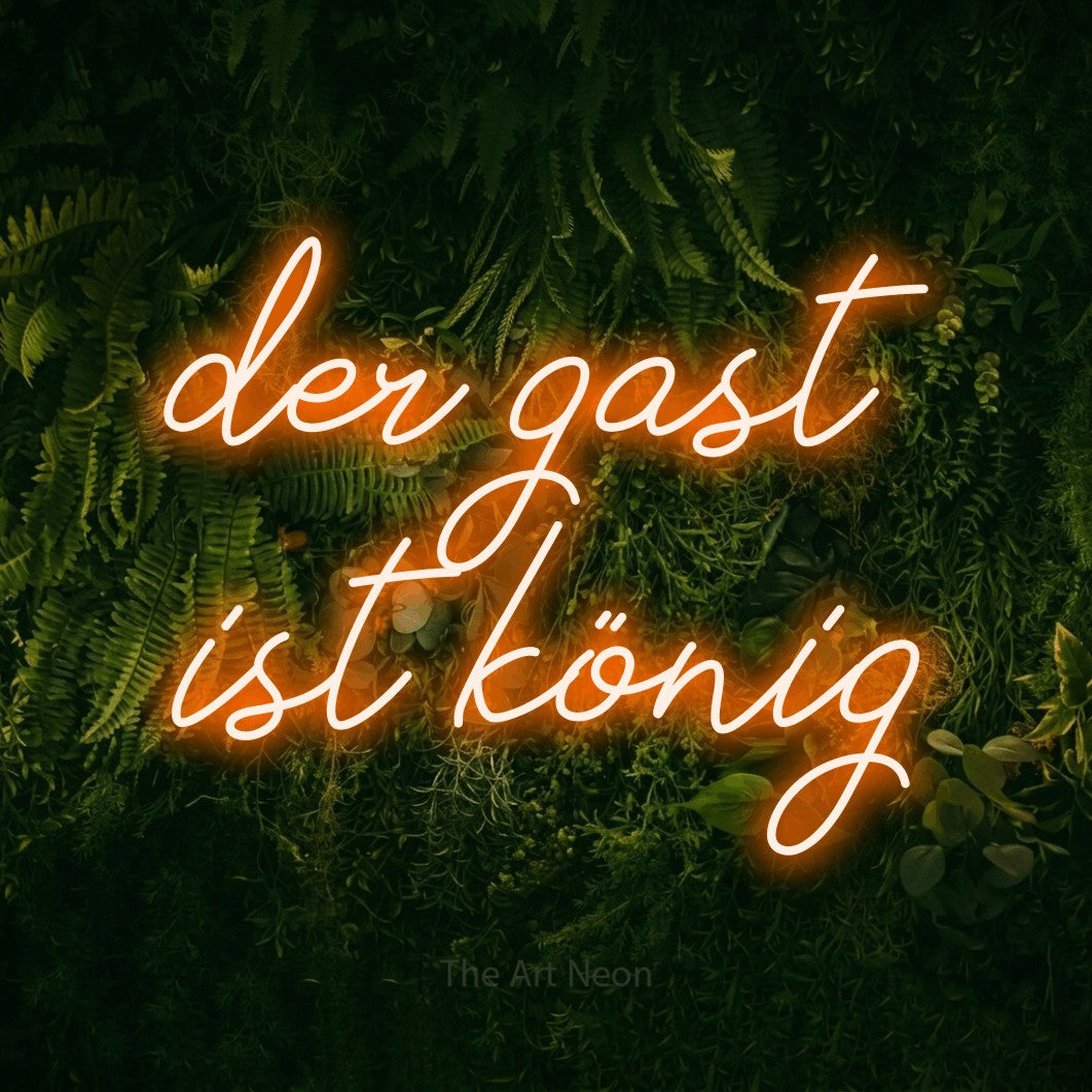LED neon sign reading “der gast ist könig”, arranged in 2 lines.