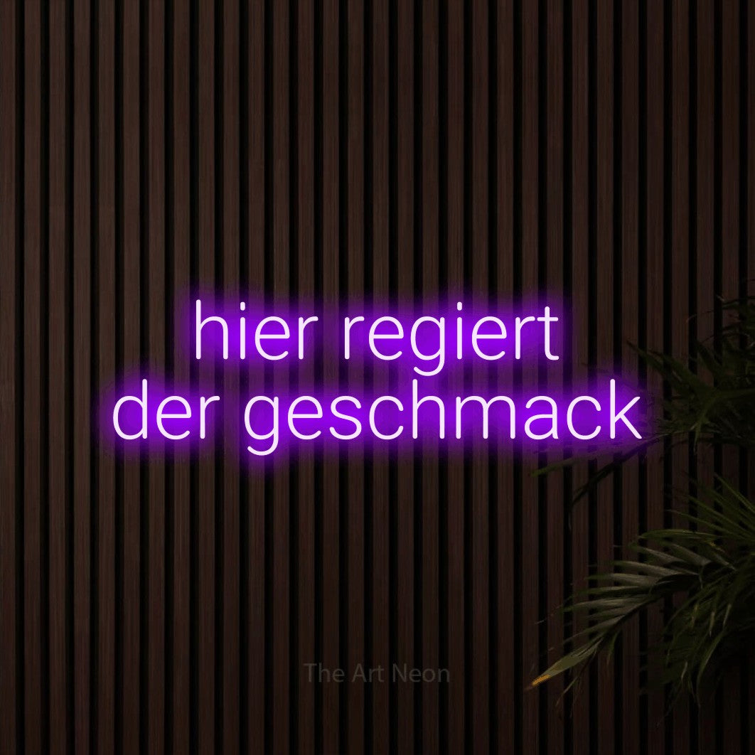 LED neon sign reading “hier regiert der geschmack”, arranged in 2 lines.