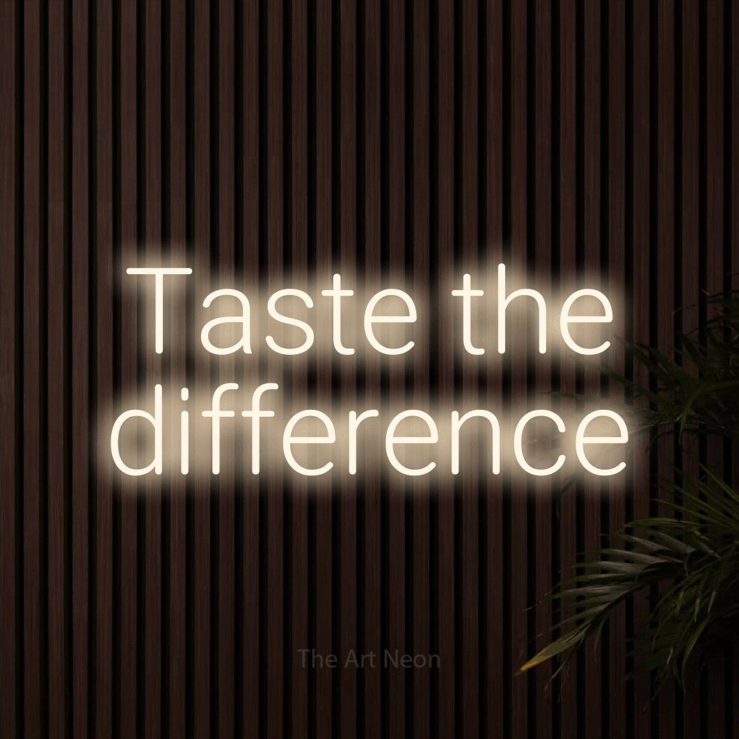 LED neon sign reading “Taste the difference”, arranged in 2 lines.