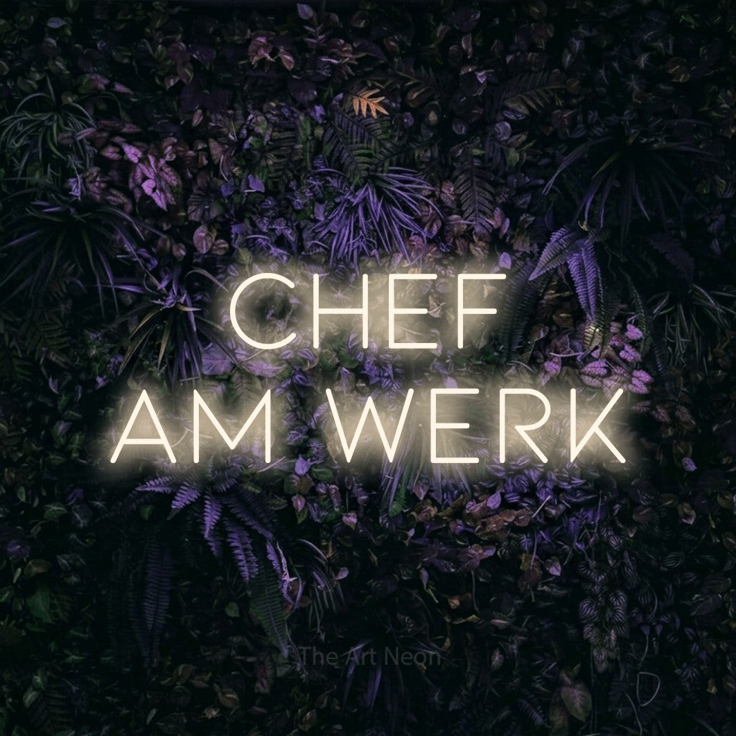 LED neon sign reading “chef am werk”, arranged in 2 lines.