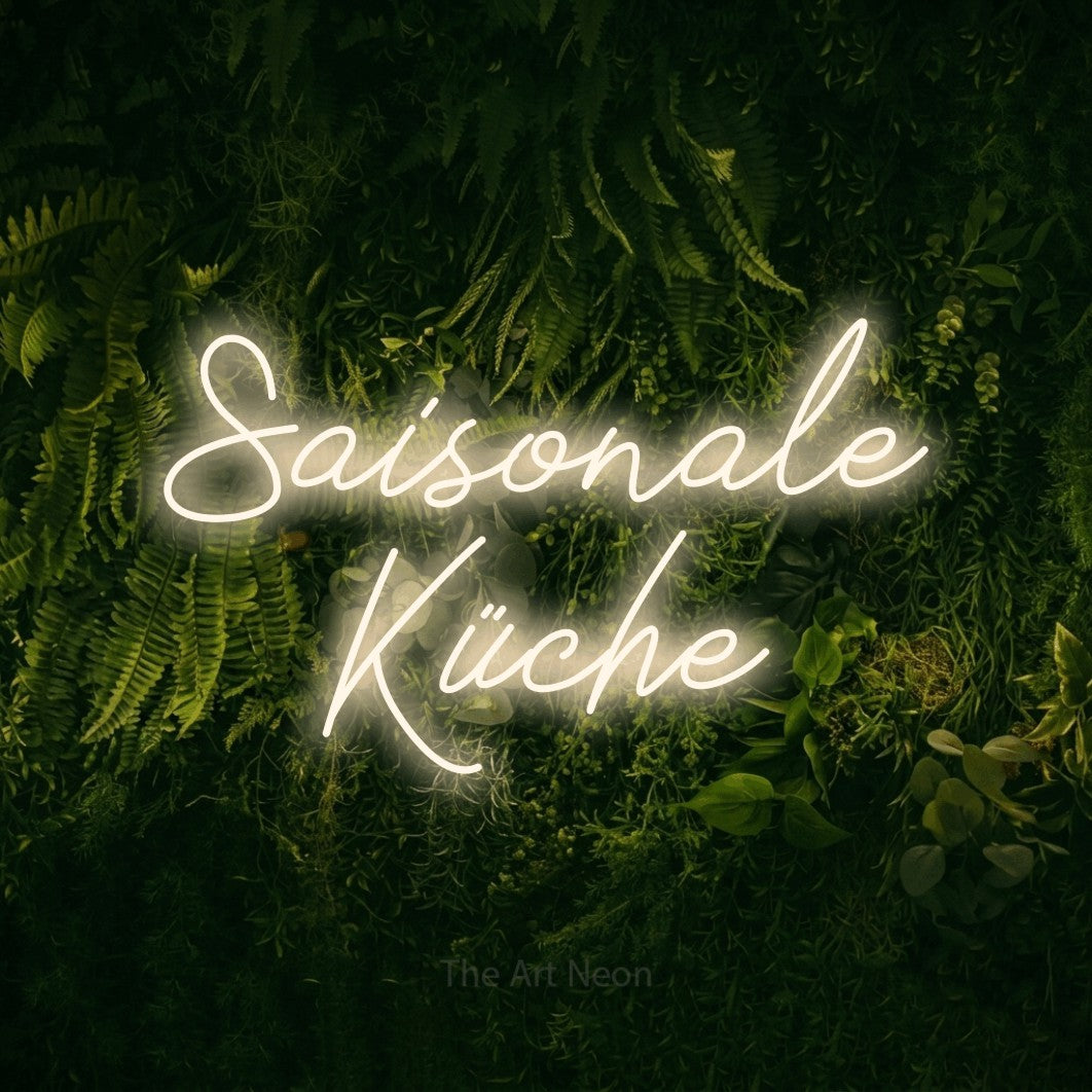 LED neon sign reading “Saisonale Küche”, arranged in 2 lines.