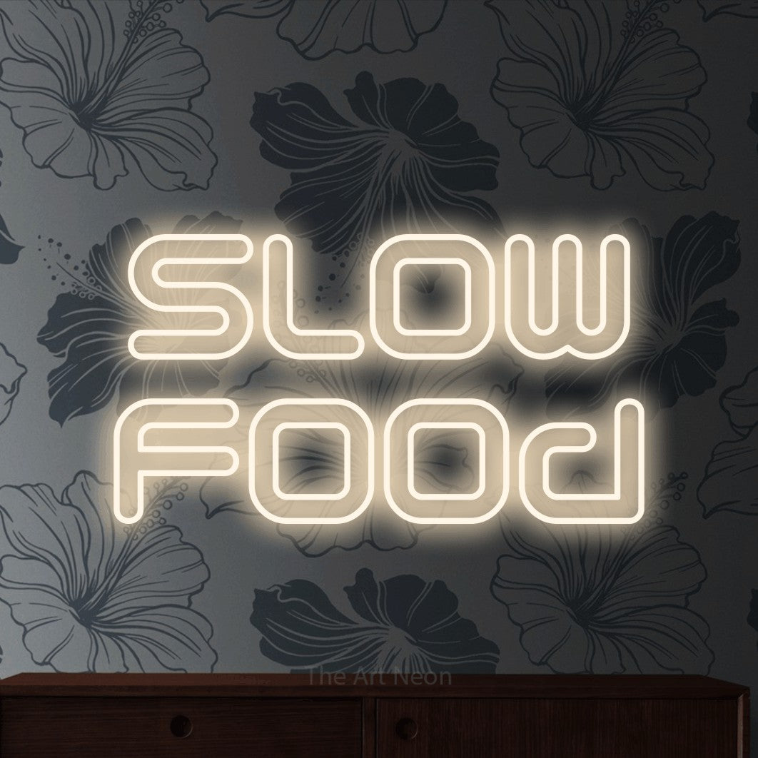 LED neon sign reading “slow food”, arranged in 2 lines.