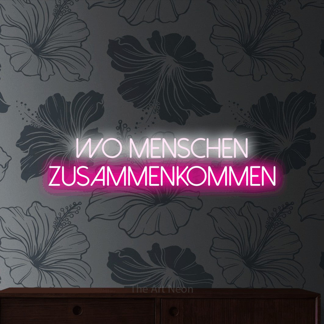 LED neon sign reading “Wo Menschen zusammenkommen”, arranged in 2 lines.