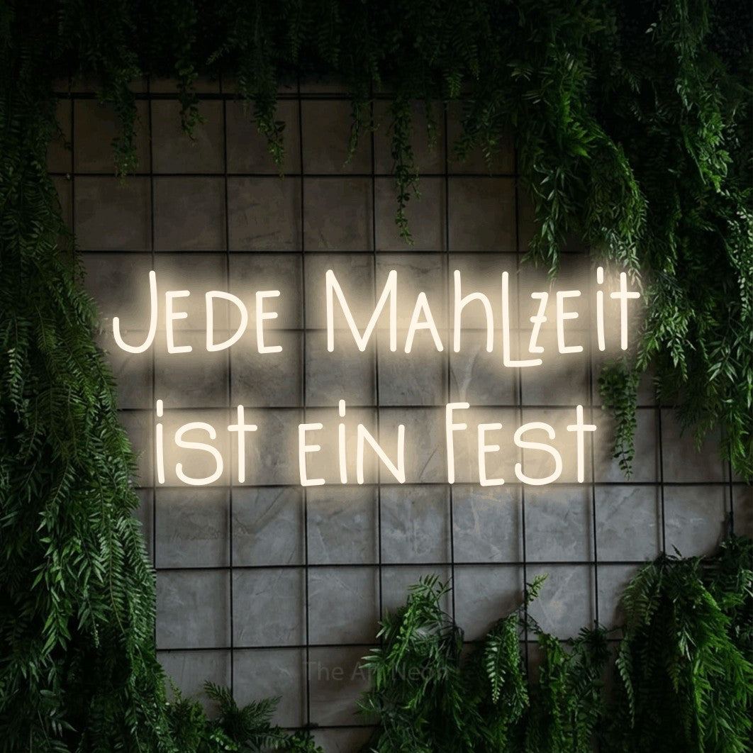 LED neon sign reading “Jede Mahlzeit ist ein Fest”, arranged in 2 lines.