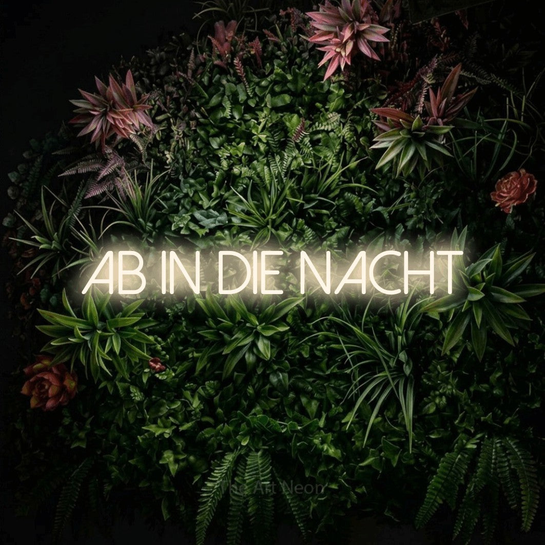LED neon sign reading “Ab in die Nacht”, arranged in a single line.