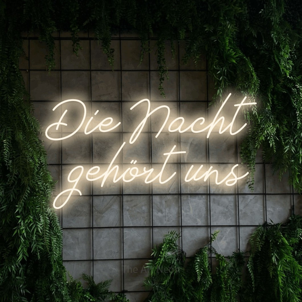 LED neon sign reading “Die Nacht gehört uns”, arranged in 2 lines.