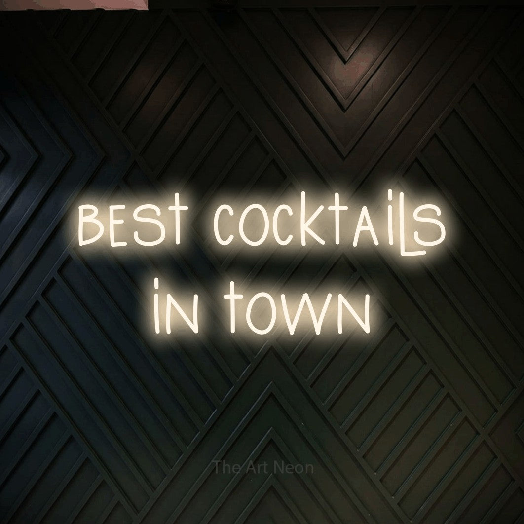 LED neon sign reading “best cocktails in town”, arranged in 2 lines.
