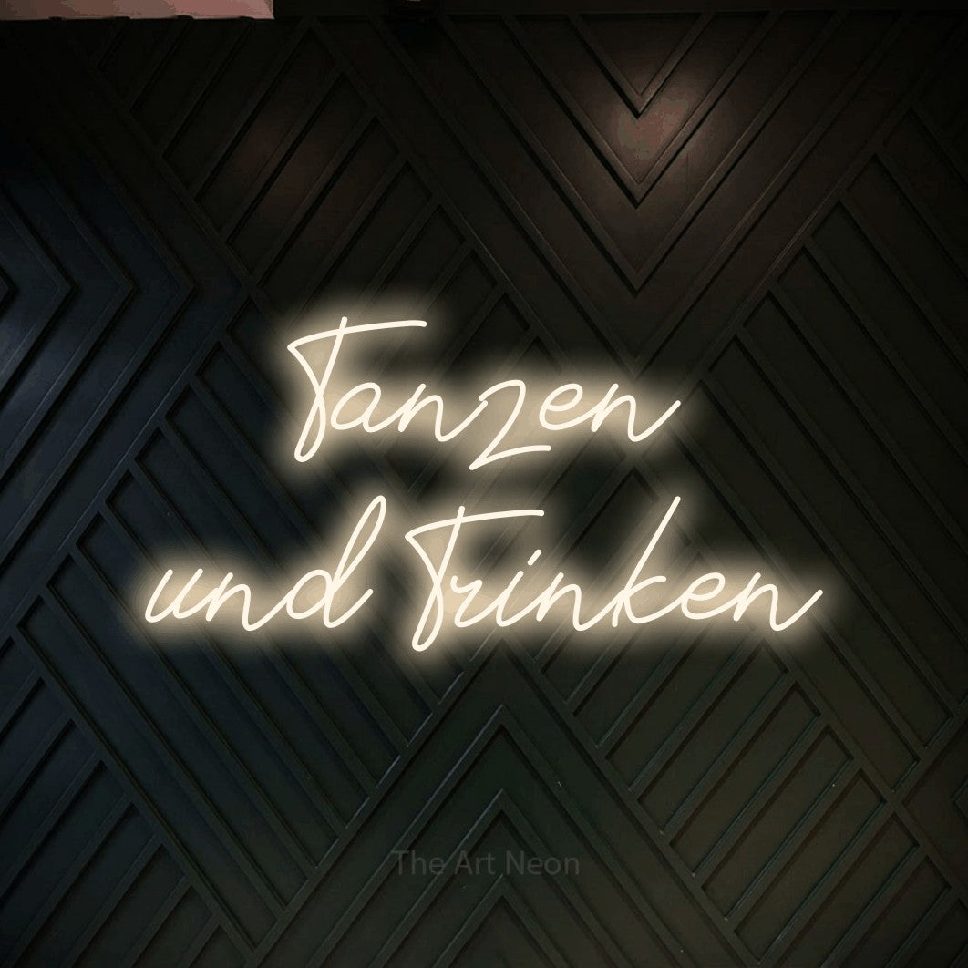 LED neon sign reading “Tanzen und Trinken”, arranged in 2 lines.