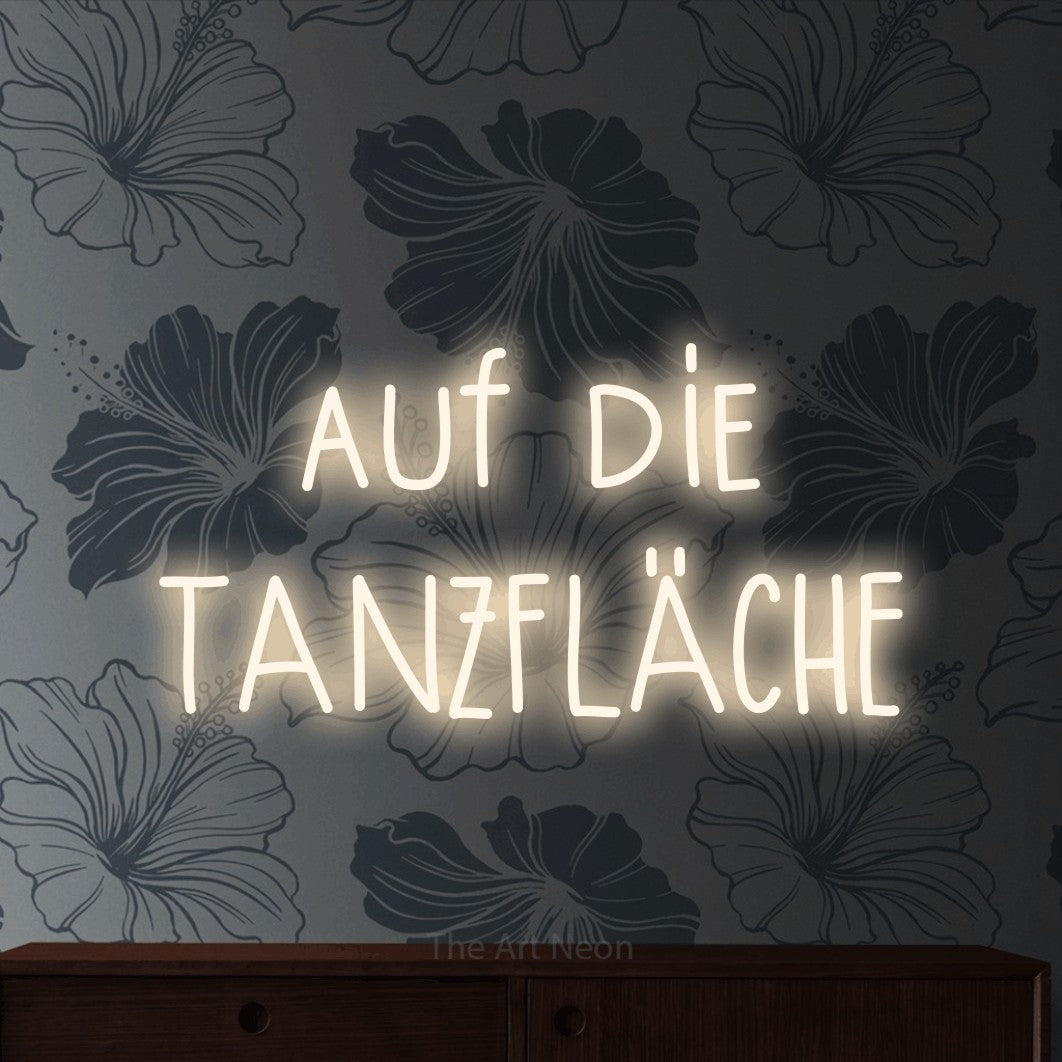 LED neon sign reading “auf die TANZFLÄCHE”, arranged in 2 lines.
