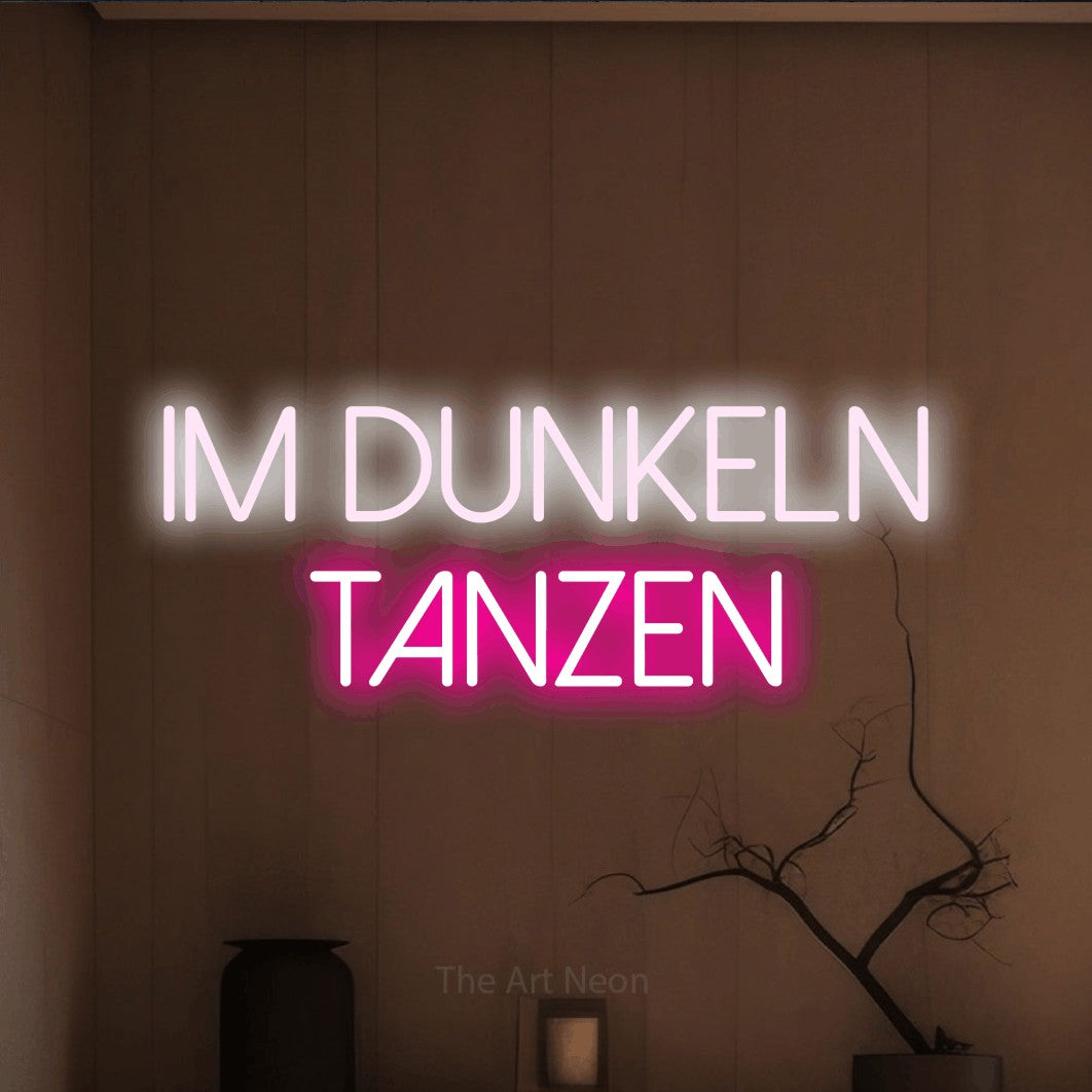 LED neon sign reading “IM DUNKELN TANZEN”, arranged in 2 lines.