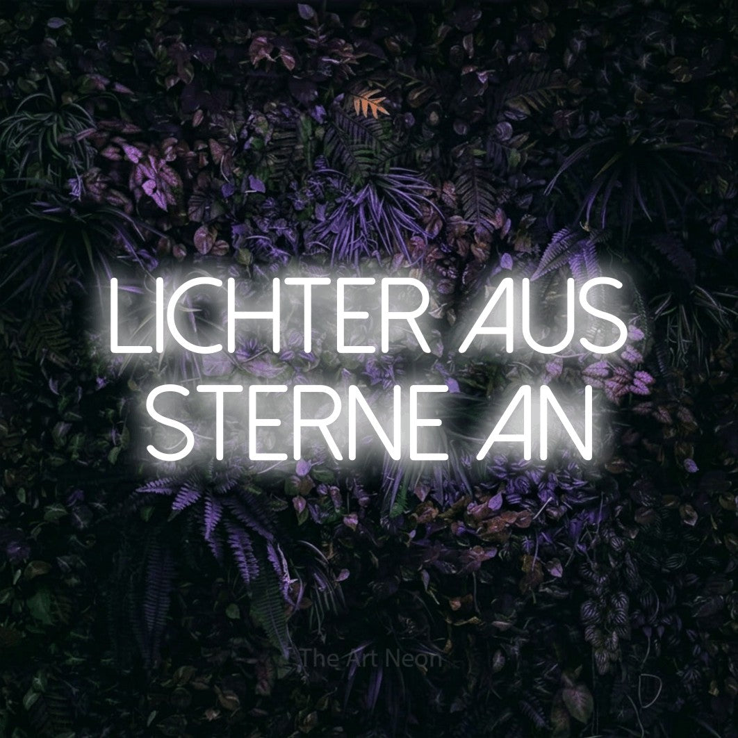 LED neon sign reading “Lichter aus Sterne an”, arranged in 2 lines.
