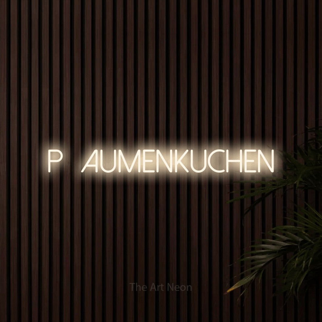 LED neon sign reading “Pflaumenkuchen”, arranged in a single line.