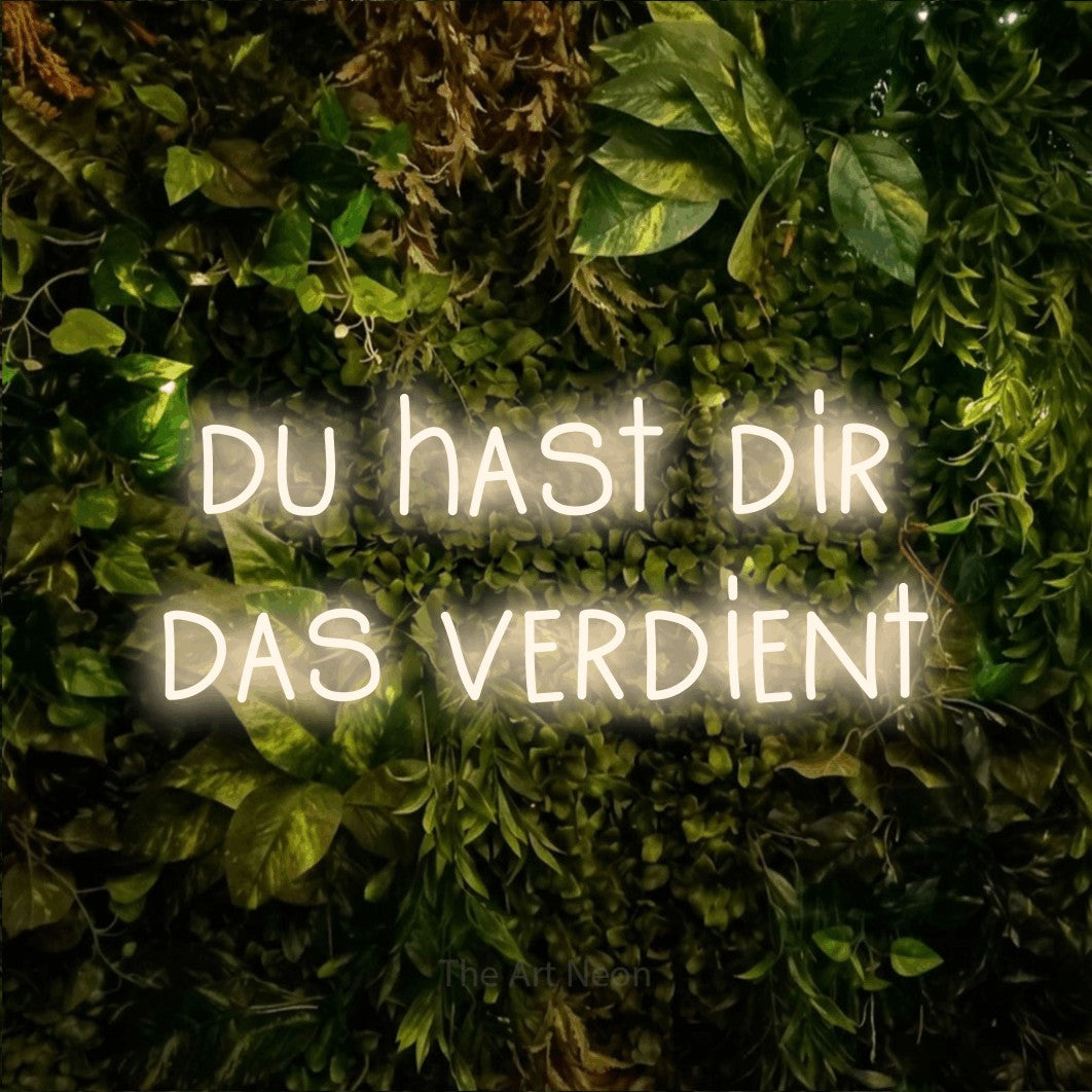 LED neon sign reading “du hast dir das verdient”, arranged in 2 lines.