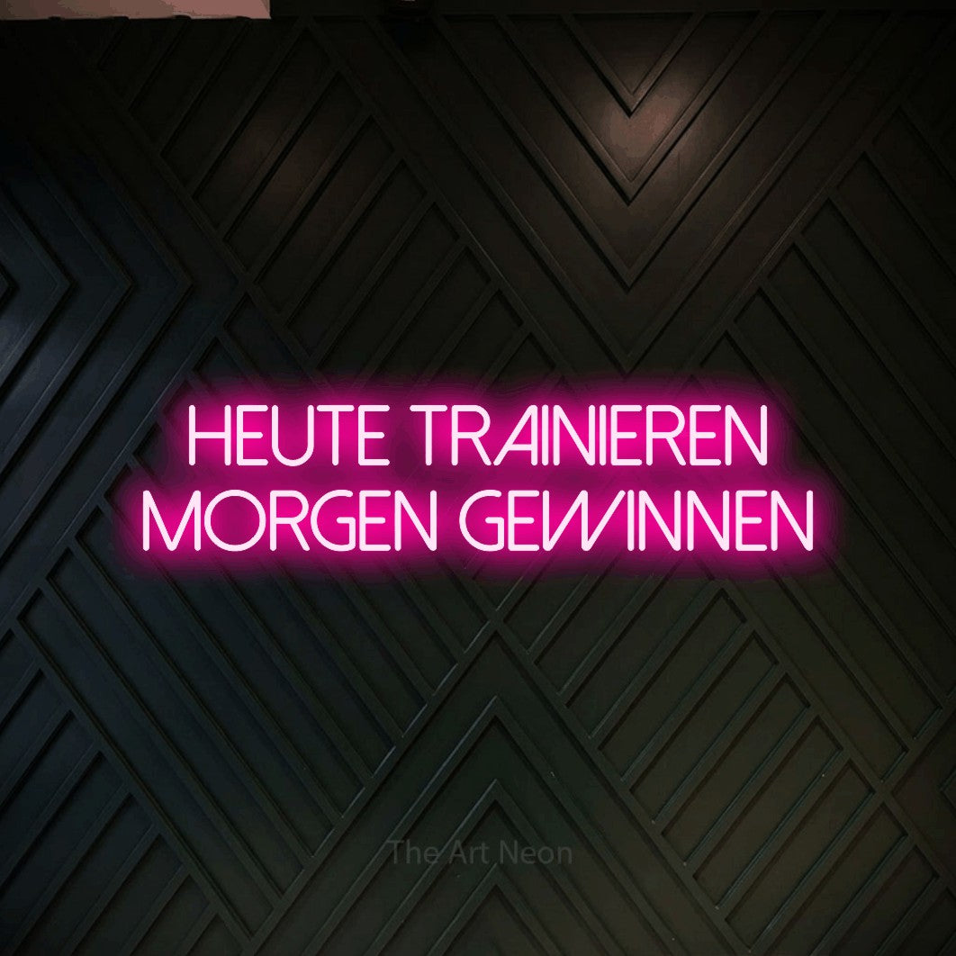 LED neon sign reading “heute trainieren morgen gewinnen”, arranged in 2 lines.