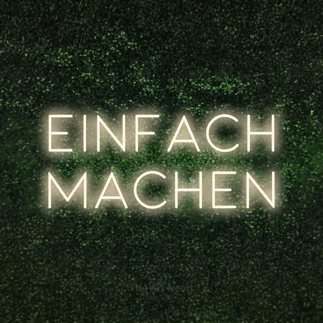 LED neon sign reading “EINFACH MACHEN”, arranged in 2 lines.