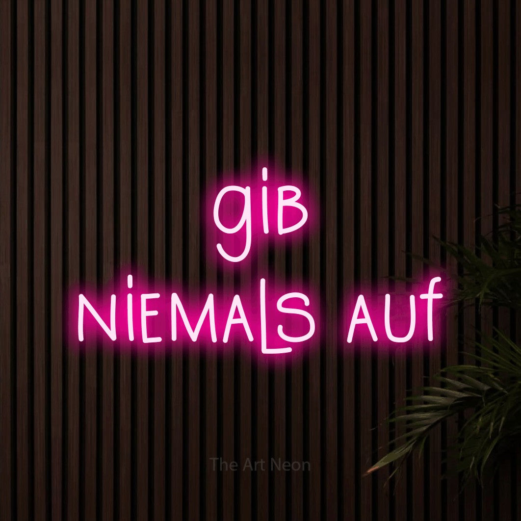 LED neon sign reading “gib niemals auf”, arranged in 2 lines.