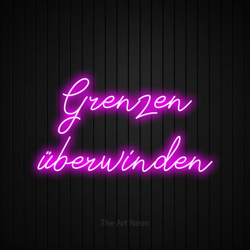 LED neon sign reading “Grenzen überwinden”, arranged in 2 lines.