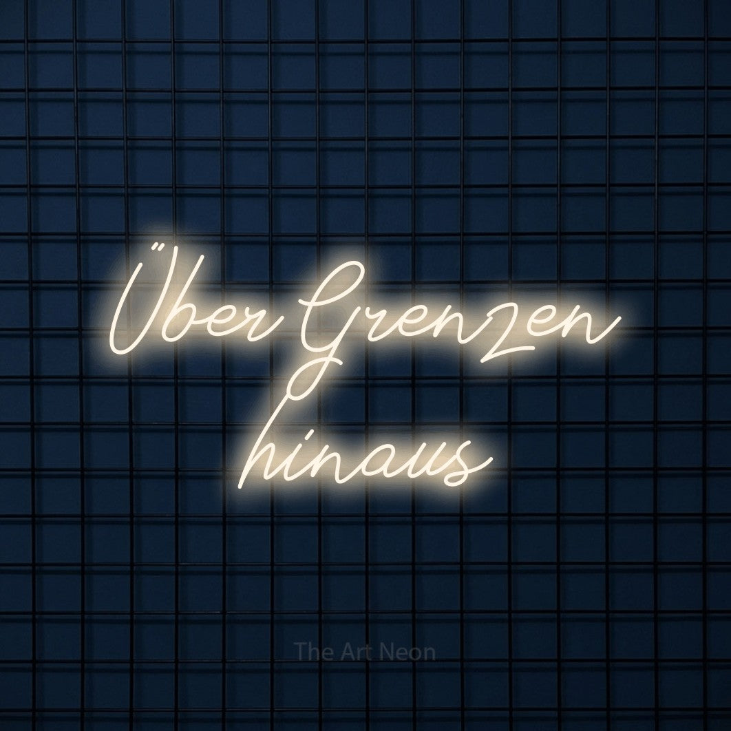 LED neon sign reading “Über Grenzen hinaus”, arranged in 2 lines.