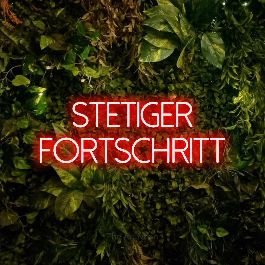 LED neon sign reading “STETIGER FORTSCHRITT”, arranged in 2 lines.