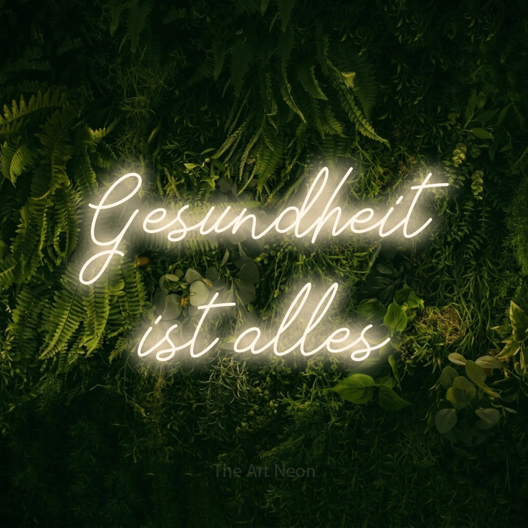 LED neon sign reading “Gesundheit ist alles”, arranged in 2 lines.
