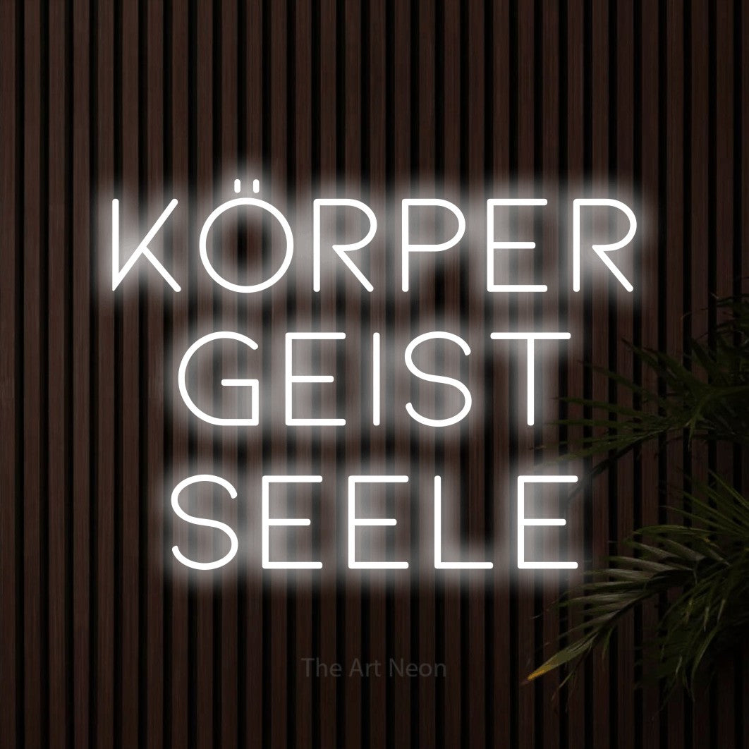 LED neon sign reading “Körper Geist Seele”, arranged in 3 lines.