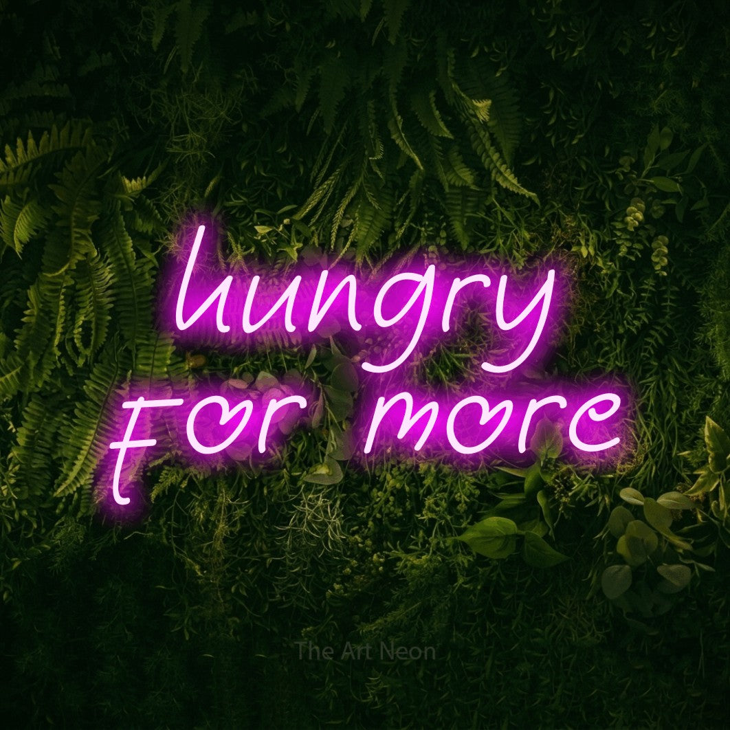 LED neon sign reading “hungry for more”, arranged in 2 lines.