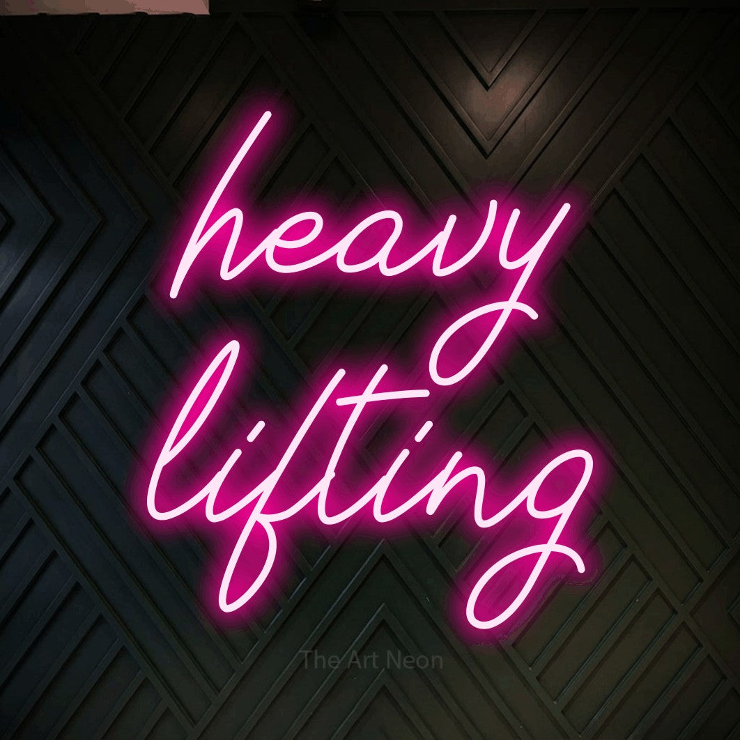 LED neon sign reading “heavy lifting”, arranged in 2 lines.