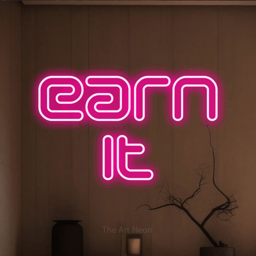 LED neon sign reading “earn it”, arranged in 2 lines.