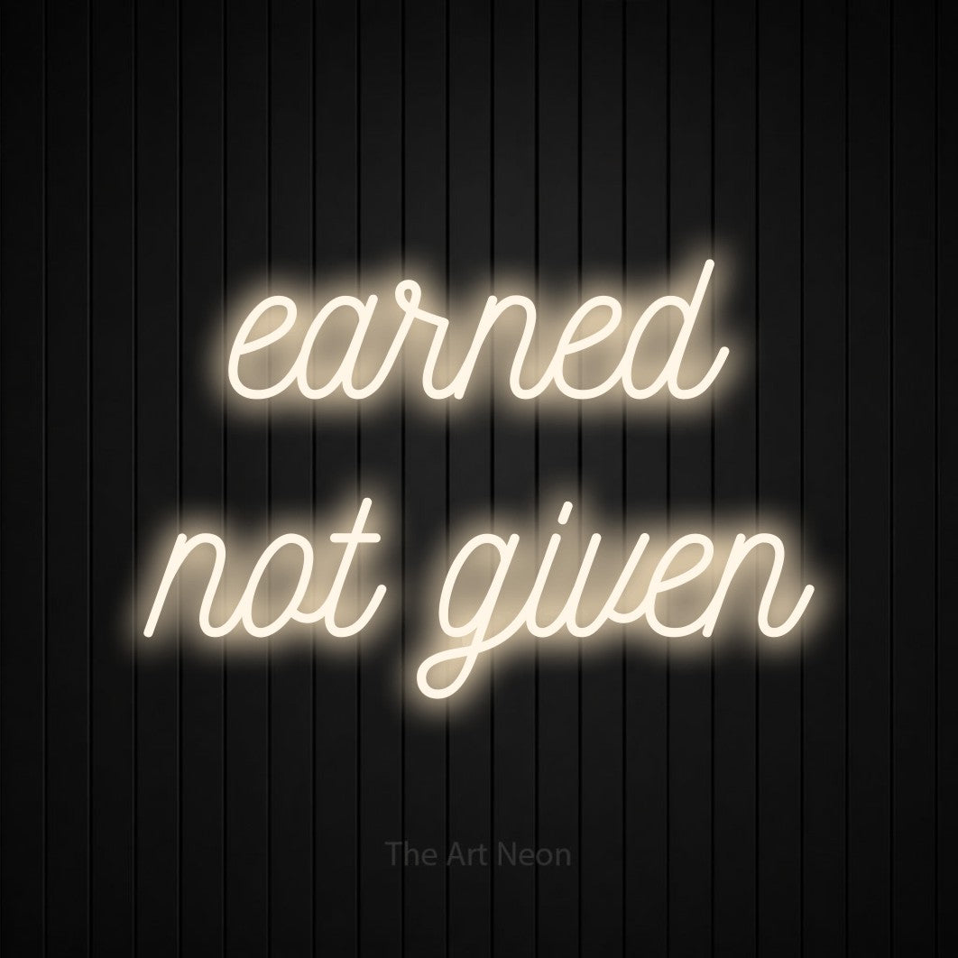 LED neon sign reading “earned not given”, arranged in 2 lines.