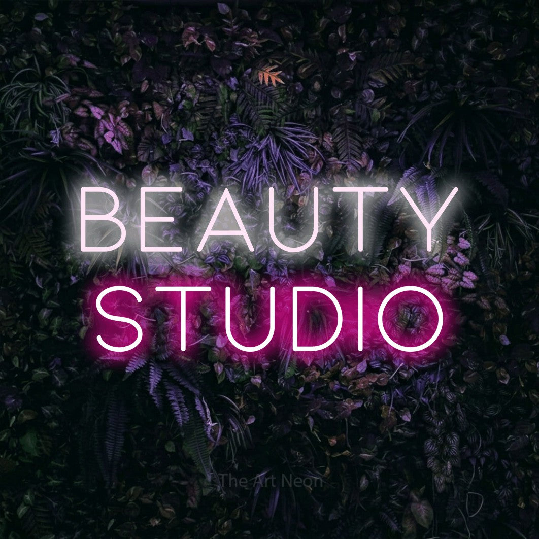 LED neon sign reading “beauty studio”, arranged in 2 lines.