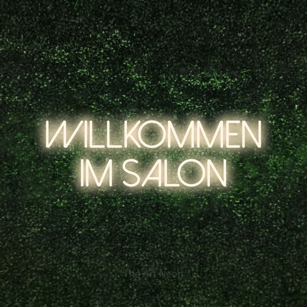 LED neon sign reading “willkommen im salon”, arranged in 2 lines.