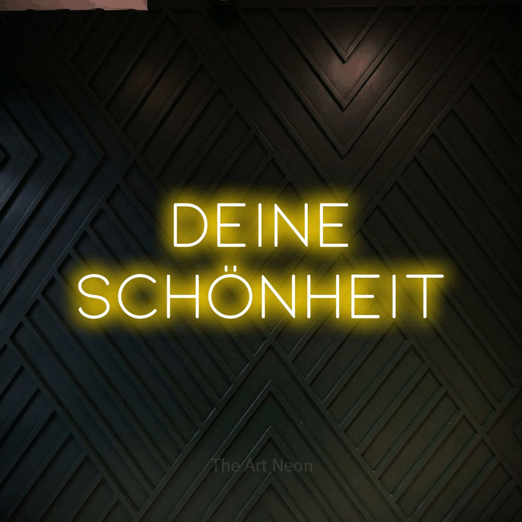 LED neon sign reading “DEINE SCHÖNHEIT”, arranged in 2 lines.