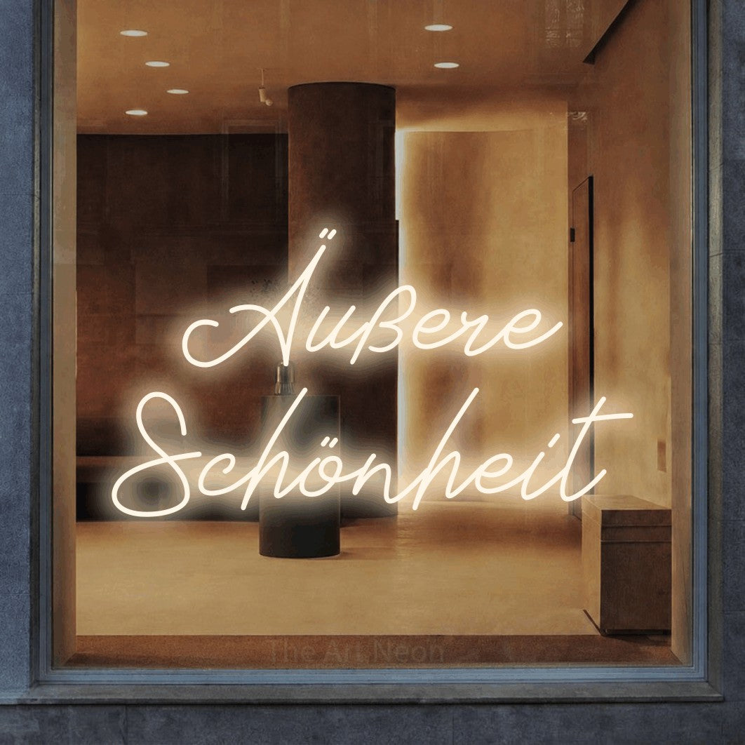 LED neon sign reading “Äußere Schönheit”, arranged in 2 lines.