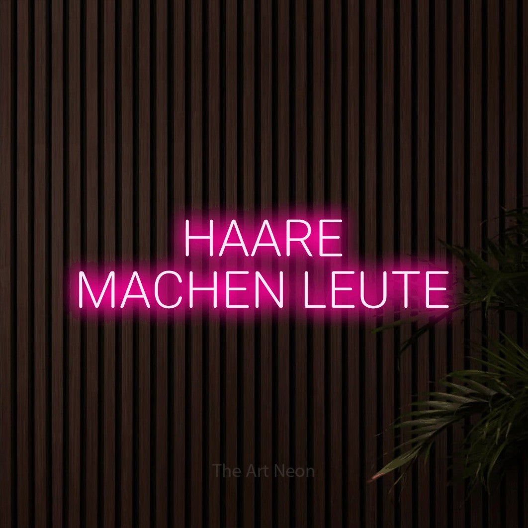 LED neon sign reading “HAARE MACHEN LEUTE”, arranged in 2 lines.