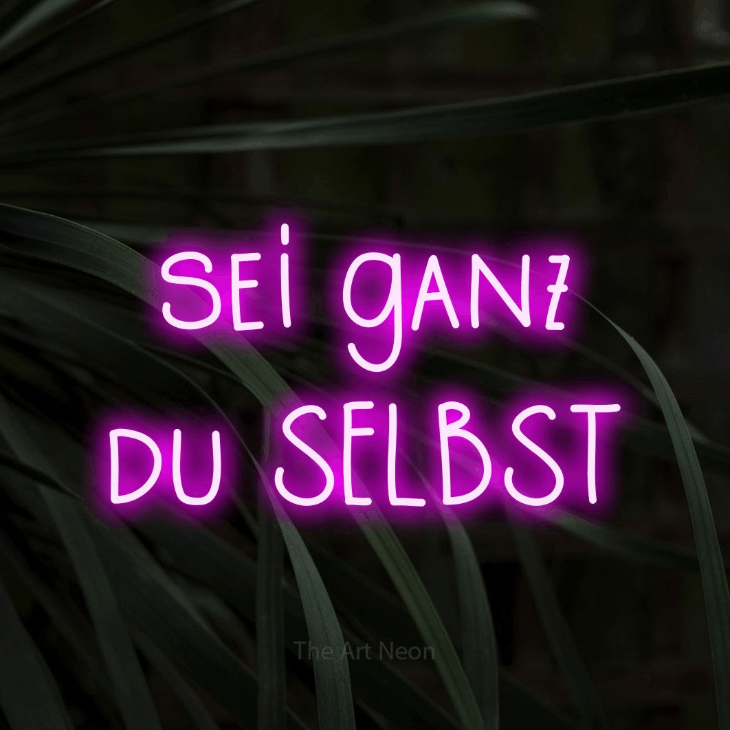 LED neon sign displaying “sei ganz du SELBST”.