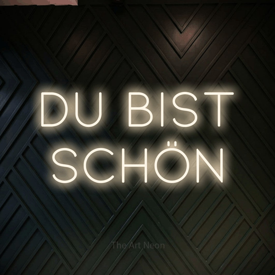 LED neon sign reading “DU BIST SCHÖN”, arranged in 2 lines.