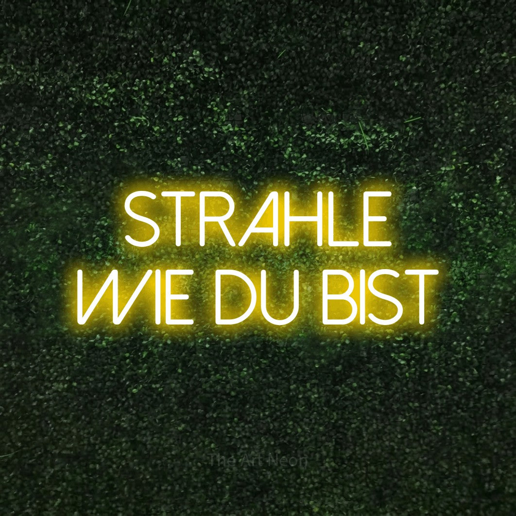 LED neon sign reading “Strahle wie du bist”, arranged in 2 lines.