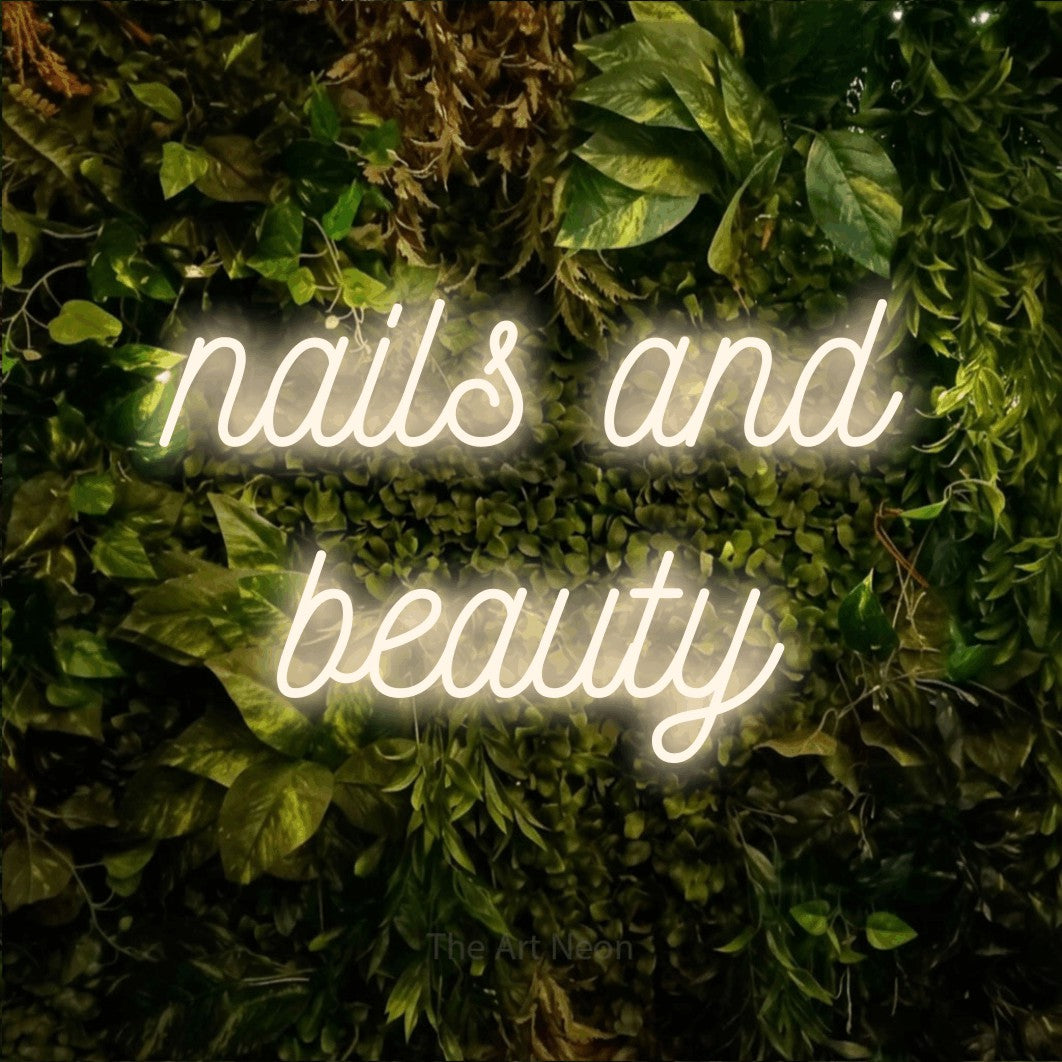 LED neon sign reading “nails and beauty”, arranged in 2 lines.