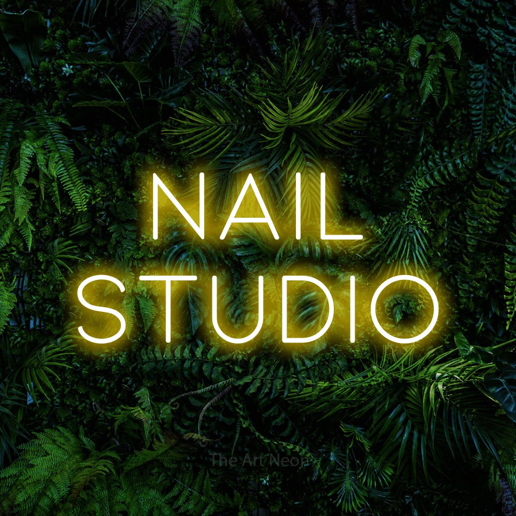 LED neon sign reading “Nail Studio”, arranged in 2 lines.
