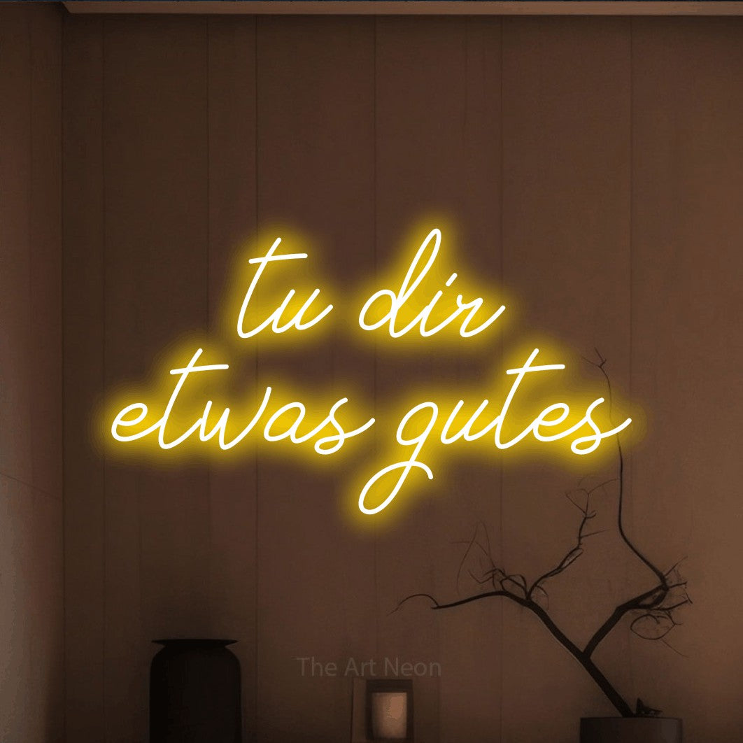 LED neon sign displaying “tu dir etwas gutes”.
