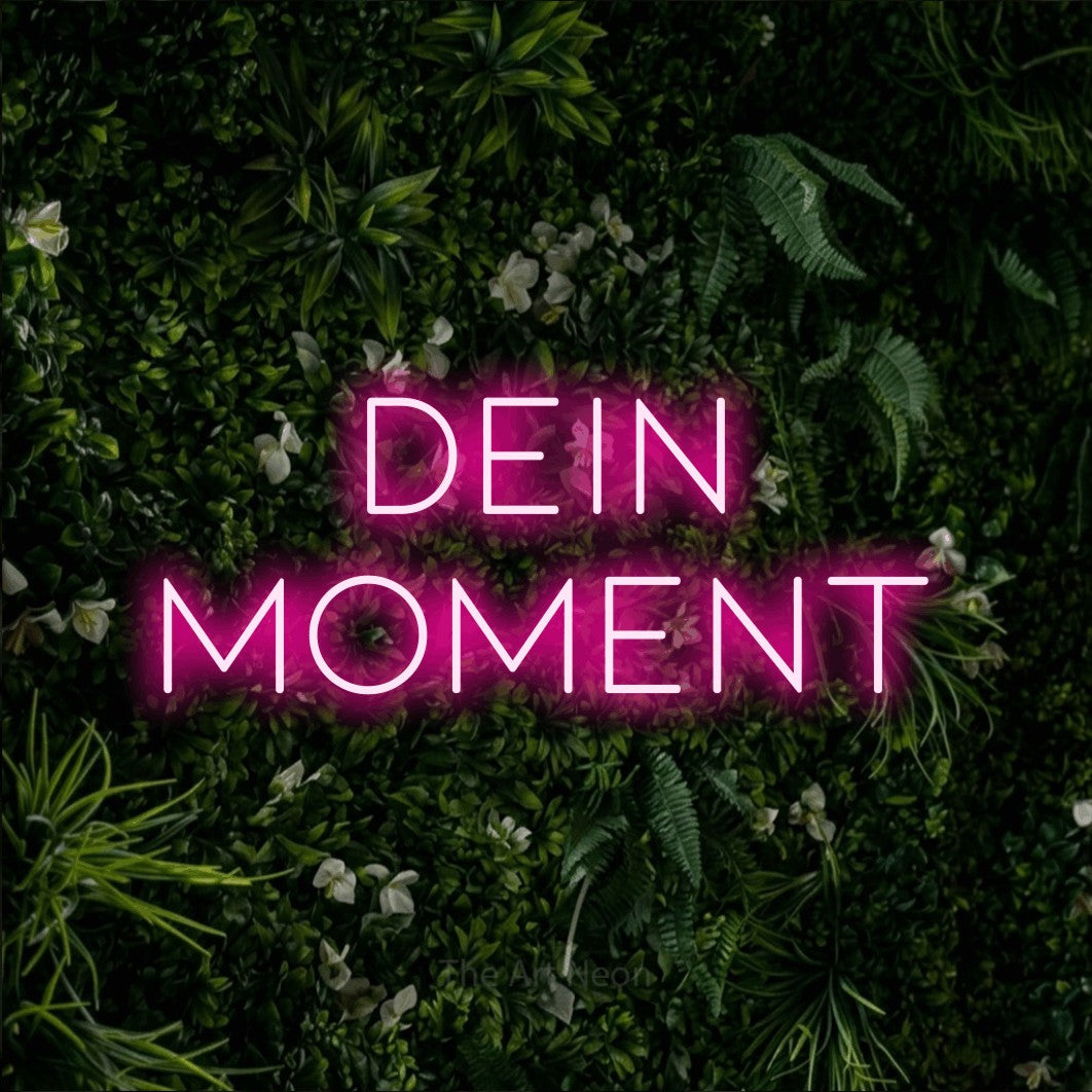 LED neon sign reading “dein moment”, arranged in 2 lines.