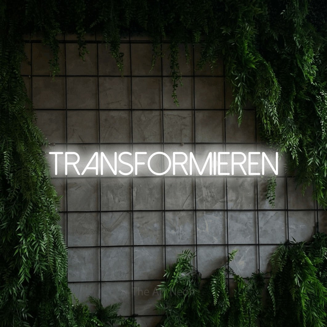 LED neon sign reading “Transformieren”, arranged in a single line.